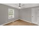 Neutral bedroom with window, ceiling fan, and wood-look flooring at 2220 Ross Cauthen Rd, Lancaster, SC 29720