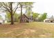 Traditional brick home with a long driveway and a detached garage, set on a sprawling lawn with mature trees at 2220 Ross Cauthen Rd, Lancaster, SC 29720