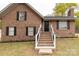 Brick facade home featuring a newly constructed front entrance, highlighted by a dark door and well-kept landscaping at 2220 Ross Cauthen Rd, Lancaster, SC 29720