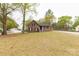 Charming brick home with a well-maintained front yard, featuring mature trees, and a long driveway at 2220 Ross Cauthen Rd, Lancaster, SC 29720