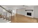 Open-concept living area with fireplace, adjacent kitchen, and staircase that offers seamless flow between spaces at 2220 Ross Cauthen Rd, Lancaster, SC 29720
