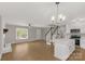 Open-concept living space with white kitchen, island, and staircase at 2220 Ross Cauthen Rd, Lancaster, SC 29720