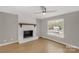 Bright living room features a painted brick fireplace and a modern ceiling fan at 2220 Ross Cauthen Rd, Lancaster, SC 29720