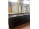 Bathroom vanity with dual sinks, dark wood cabinetry, and granite countertop at 353 Montibello Dr, Mooresville, NC 28117