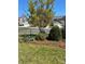 Close up of landscaped side yard with ornamental tree and black aluminum fence at 353 Montibello Dr, Mooresville, NC 28117