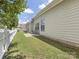 Well-maintained backyard featuring a white picket fence, grassy lawn, and a cozy patio area at 4148 Cedar Point Ave, Matthews, NC 28104