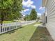 Well maintained backyard featuring a white picket fence and lush green grass at 4148 Cedar Point Ave, Matthews, NC 28104