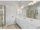 Bright bathroom featuring a double vanity, ample storage, and a glass-enclosed shower at 4148 Cedar Point Ave, Matthews, NC 28104