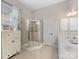 Bright bathroom featuring tiled floors, a glass-enclosed shower, and a double vanity sink at 4148 Cedar Point Ave, Matthews, NC 28104