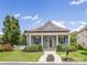 Inviting one-story home featuring a covered front porch with columns, lush landscaping, and a manicured lawn at 4148 Cedar Point Ave, Matthews, NC 28104