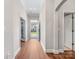 Bright hallway with hardwood flooring and views of the front door and surrounding rooms at 4148 Cedar Point Ave, Matthews, NC 28104