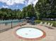 Community hot tub and pool area with seating and a fenced in area at 4148 Cedar Point Ave, Matthews, NC 28104