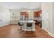 Bright kitchen with a central island, stainless steel appliances, and wood-look flooring at 4148 Cedar Point Ave, Matthews, NC 28104