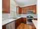 A well lit kitchen featuring gray backsplash, stainless steel appliances and wood-look flooring at 4148 Cedar Point Ave, Matthews, NC 28104