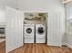 Convenient laundry closet with a washer, dryer, and shelving for storage at 4148 Cedar Point Ave, Matthews, NC 28104