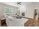 Bright living room with a cozy fireplace, lots of light and a comfortable sectional at 4148 Cedar Point Ave, Matthews, NC 28104