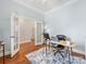 Home office with french doors, wood floors, and a light blue accent wall at 4148 Cedar Point Ave, Matthews, NC 28104
