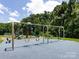 Community playground with slides, swings, and benches surrounded by trees at 4148 Cedar Point Ave, Matthews, NC 28104