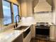 Open kitchen featuring stainless appliances, white cabinets, and marble backsplash at 141 Sunrise Pt, New London, NC 28127