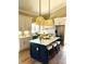 Bright eat-in kitchen featuring a large center island, stainless steel appliances, and decorative hanging lights at 141 Sunrise Pt, New London, NC 28127