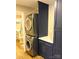 A functional laundry room with stacked washer/dryer and storage cabinets for organization at 141 Sunrise Pt, New London, NC 28127