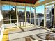 Screened porch with furniture overlooking a peaceful lake scene at 141 Sunrise Pt, New London, NC 28127