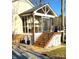 Lovely screened-in porch with wooden steps, railing, and serene outdoor views at 141 Sunrise Pt, New London, NC 28127
