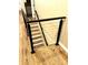 Modern staircase with horizontal cable railing and wooden treads leads to the lower level at 141 Sunrise Pt, New London, NC 28127