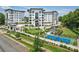 Stunning aerial view showcasing the luxury condo community, manicured lawns, tennis court, and lush landscaping at 19329 Watermark Dr # 142, Cornelius, NC 28031