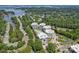Aerial view of a luxury condo complex near the lake, surrounded by mature trees and lush greenery at 19329 Watermark Dr # 142, Cornelius, NC 28031