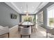 Open dining room featuring a large table, modern lighting, and access to outdoor views at 19329 Watermark Dr # 142, Cornelius, NC 28031