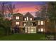 Spacious brick home with backyard, stone chimney, patio, and fenced yard, perfect for outdoor living at 4273 Stormy Pointe Ct, Denver, NC 28037