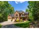 Charming two-story brick home with a covered porch, lush landscaping, and a three-car garage at 4273 Stormy Pointe Ct, Denver, NC 28037