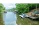 Beautiful waterfront property with boat docks, gazebos, and serene lake views surrounded by lush greenery at 4273 Stormy Pointe Ct, Denver, NC 28037