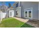 View of backyard featuring well maintained artificial turf and doors to interior at 1111 Johns Walk Way, Belmont, NC 28012