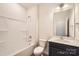 Well-lit bathroom featuring bathtub with shower, white fixtures, and vanity at 1111 Johns Walk Way, Belmont, NC 28012