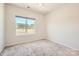 Bright bedroom featuring a window overlooking trees and carpeted floors at 1111 Johns Walk Way, Belmont, NC 28012