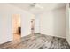Bright bedroom features sleek wood-look floors, ceiling fan, and ensuite bath access at 1111 Johns Walk Way, Belmont, NC 28012