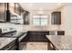 Kitchen featuring granite counters, stainless appliances, and dark cabinets at 1111 Johns Walk Way, Belmont, NC 28012