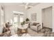 A staged living room with a neutral palette, ceiling fan, and access to the patio at 1111 Johns Walk Way, Belmont, NC 28012