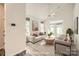 Staged living room with wood flooring, neutral furniture, ceiling fan, and backyard access at 1111 Johns Walk Way, Belmont, NC 28012
