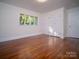 Cozy bedroom with hardwood floors, large window, and a spacious closet at 317 Belwood Dr, Belmont, NC 28012