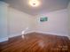 Empty room featuring hardwood floors, natural light, and modern design at 317 Belwood Dr, Belmont, NC 28012