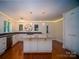 Open kitchen with granite island, stainless appliances, modern lighting, and custom cabinets, great for entertaining at 317 Belwood Dr, Belmont, NC 28012