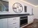 Modern kitchen featuring stainless oven, dark countertops, custom cabinetry, and decorative wine rack at 317 Belwood Dr, Belmont, NC 28012