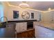 Bright kitchen boasts stainless appliances, granite countertops, wine rack feature, and custom white cabinetry at 317 Belwood Dr, Belmont, NC 28012