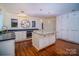 Spacious kitchen features granite counters, custom island and cabinets, stainless appliances, and decorative lighting at 317 Belwood Dr, Belmont, NC 28012