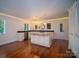 Open-concept kitchen features granite island, stainless appliances, modern lighting, and custom cabinets at 317 Belwood Dr, Belmont, NC 28012