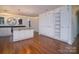 Spacious living room and kitchen boasts gleaming hardwood floors and custom cabinets with modern lighting at 317 Belwood Dr, Belmont, NC 28012