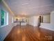 Spacious open-concept living room featuring modern lighting, hardwood floors, and ample natural light at 317 Belwood Dr, Belmont, NC 28012